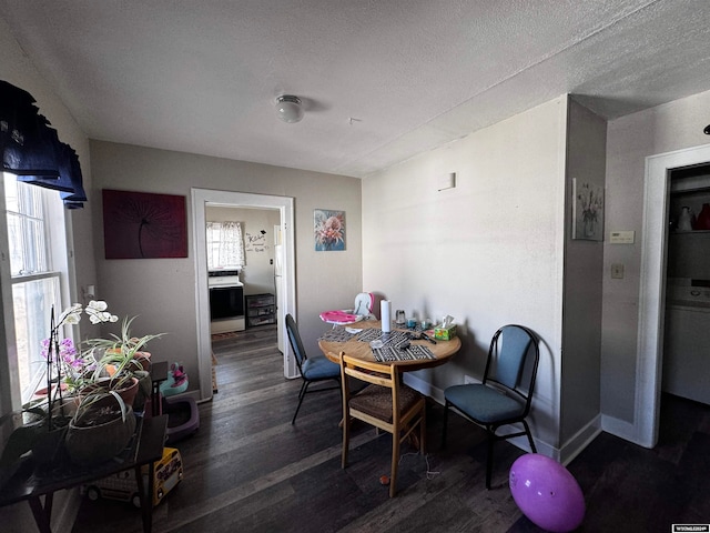 dining space with dark wood-type flooring and a textured ceiling