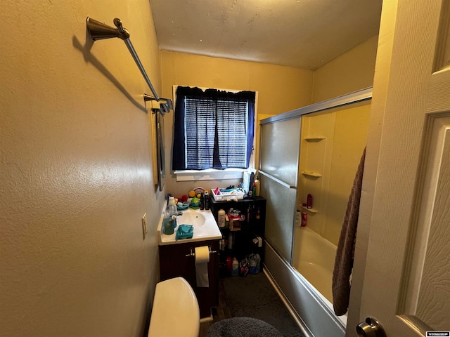 full bathroom with sink, combined bath / shower with glass door, and toilet