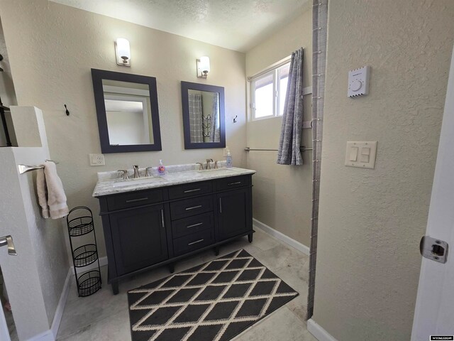 bathroom featuring oversized vanity and dual sinks