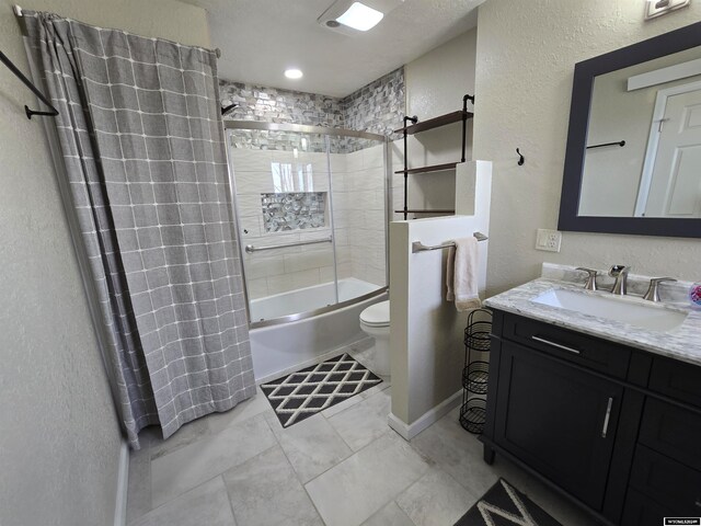 full bathroom with tiled shower / bath, toilet, tile floors, and vanity