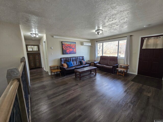 living room with a textured ceiling, a wall mounted air conditioner, and dark hardwood / wood-style floors