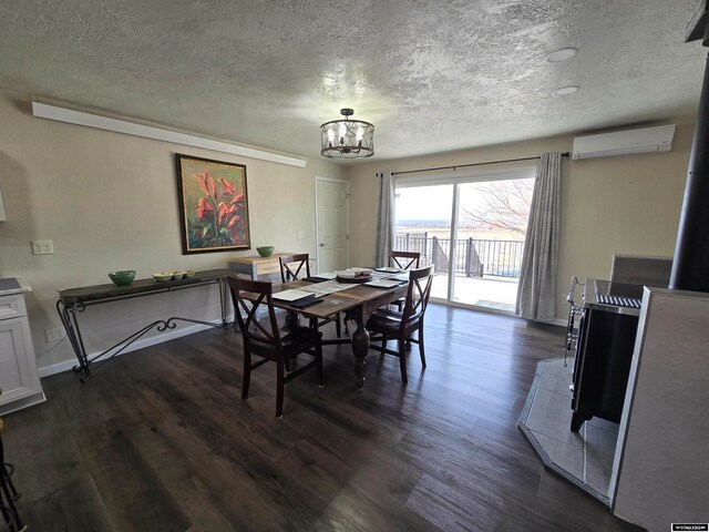 dining room with a chandelier, a wall mounted air conditioner, a textured ceiling, and dark hardwood / wood-style flooring