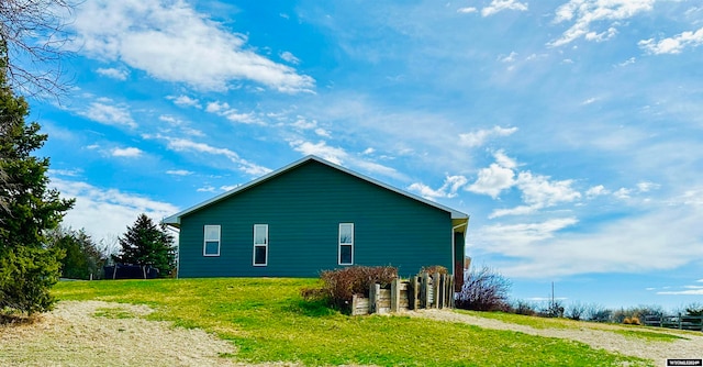 view of side of home featuring a lawn