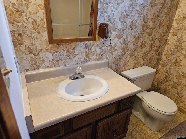 bathroom with vanity, toilet, and tile flooring