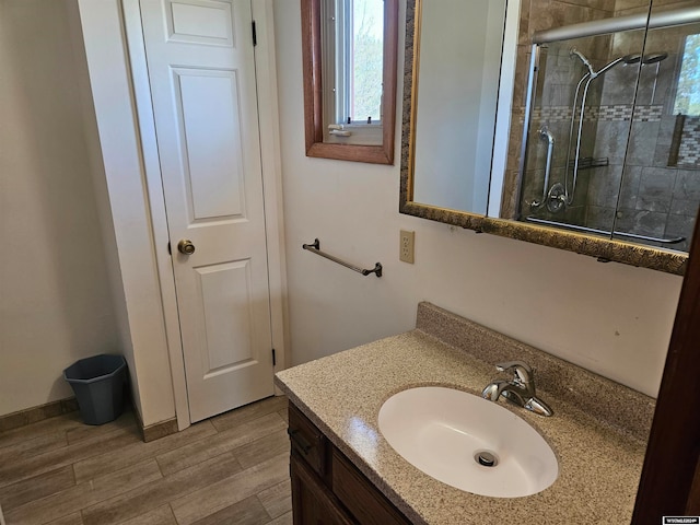 bathroom with walk in shower and large vanity