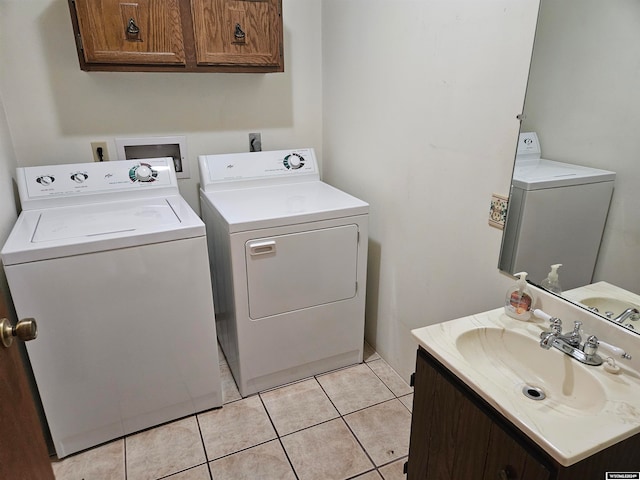 laundry area with light tile floors, washing machine and clothes dryer, sink, hookup for a washing machine, and hookup for an electric dryer