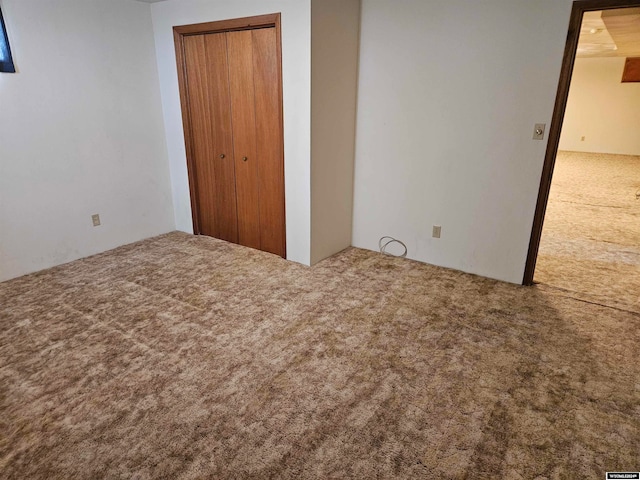 unfurnished bedroom featuring a closet and carpet floors