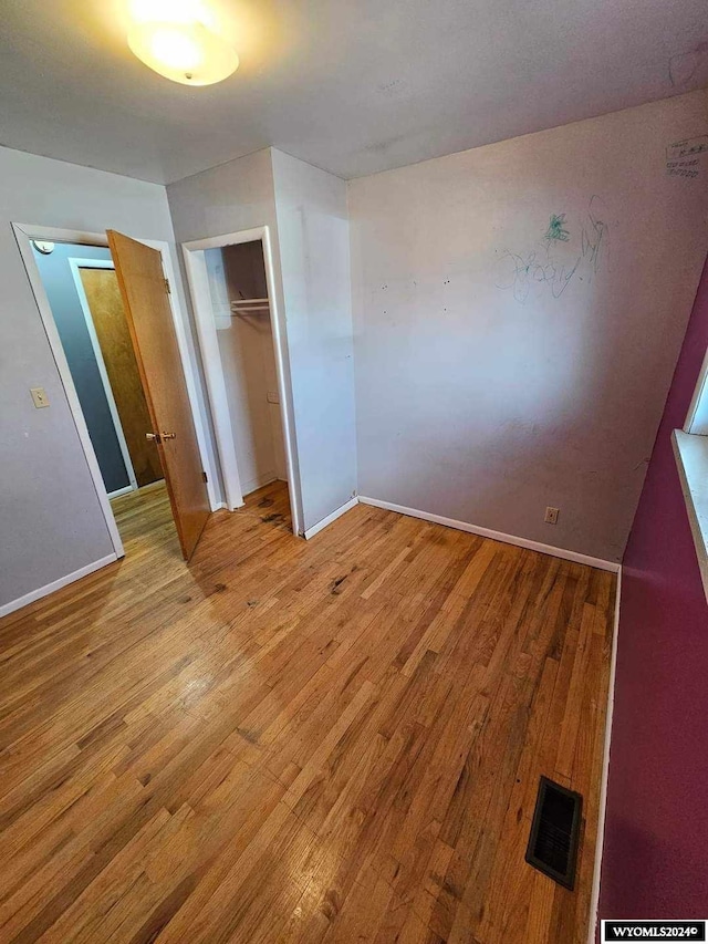 interior space with a closet and light hardwood / wood-style flooring