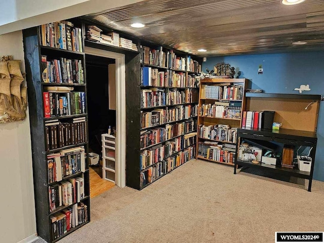 sitting room with wood ceiling and light colored carpet