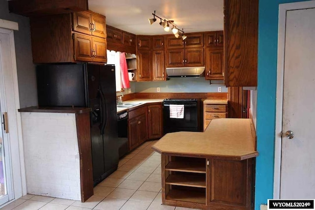 kitchen featuring sink, light tile floors, track lighting, and black appliances