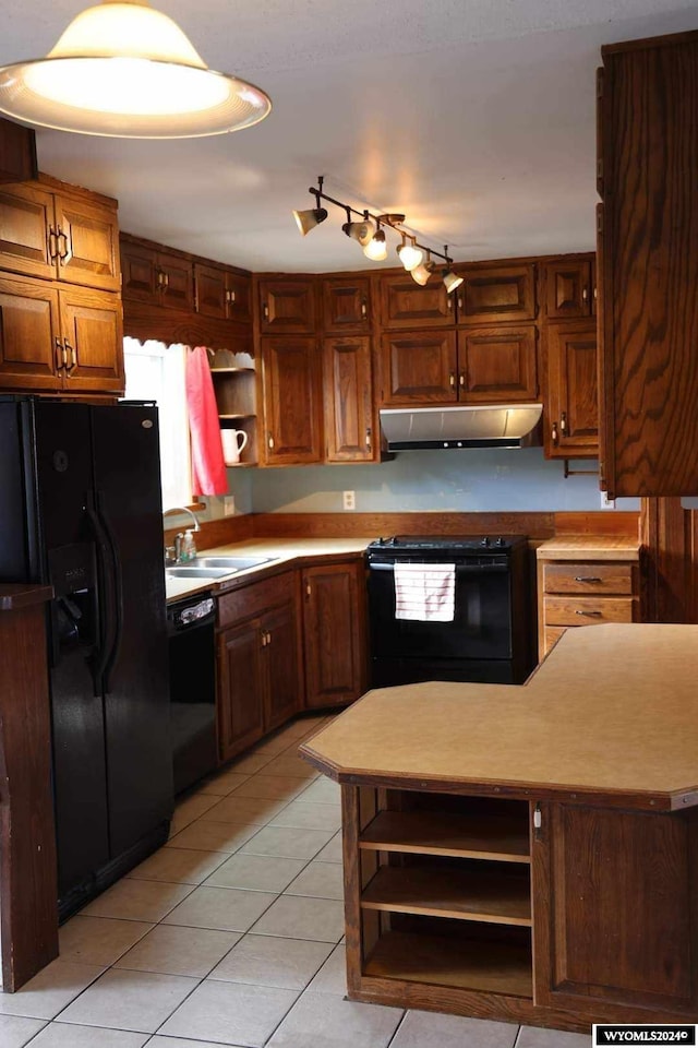 kitchen with sink, light tile floors, black appliances, and track lighting