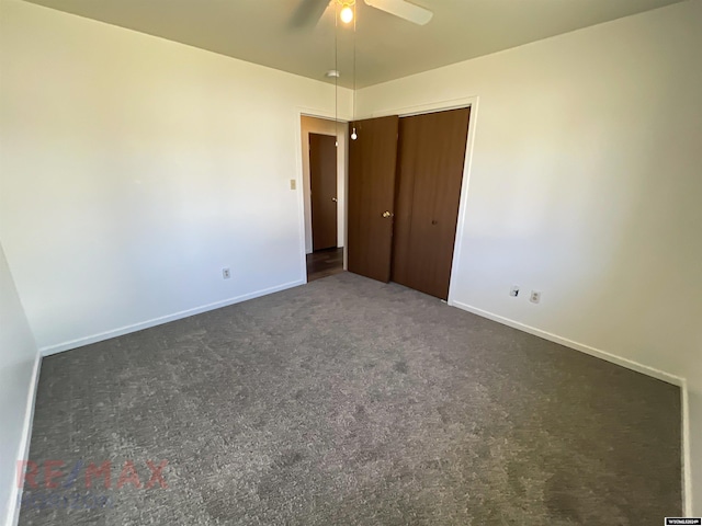 unfurnished bedroom with a closet, ceiling fan, and dark carpet