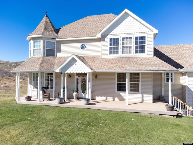 rear view of house featuring a lawn and a patio area