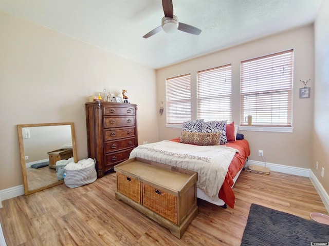 bedroom with ceiling fan and light hardwood / wood-style floors