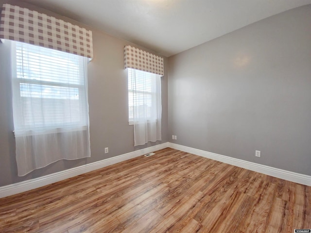 empty room featuring hardwood / wood-style flooring