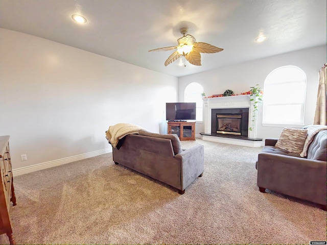 carpeted living room with ceiling fan