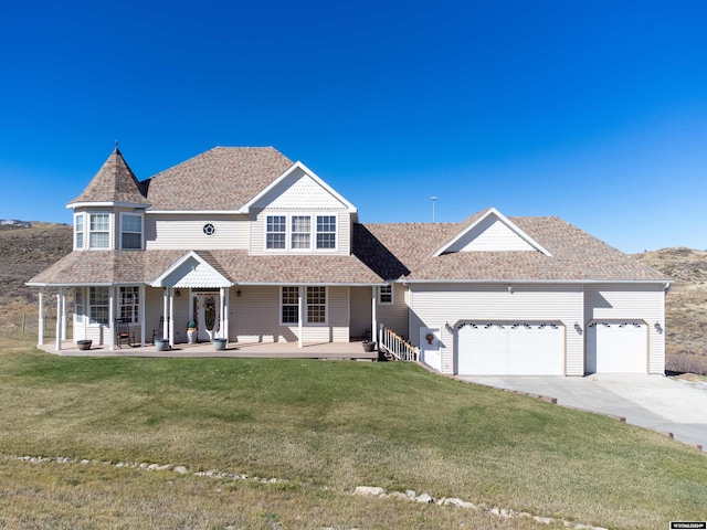 view of front of home featuring a garage, a front lawn, and a porch