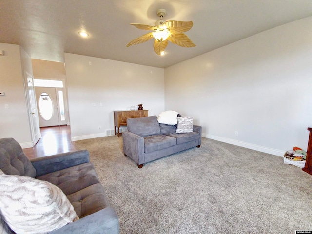 carpeted living room with ceiling fan