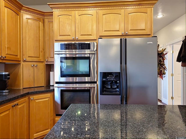 kitchen featuring dark stone counters and appliances with stainless steel finishes