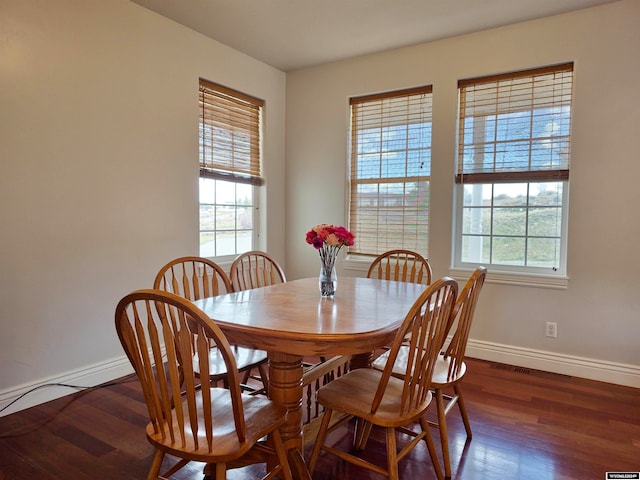 dining space featuring dark hardwood / wood-style floors