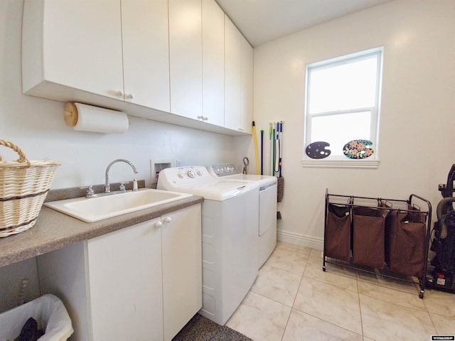 laundry room featuring washer and dryer, sink, light tile patterned floors, and cabinets