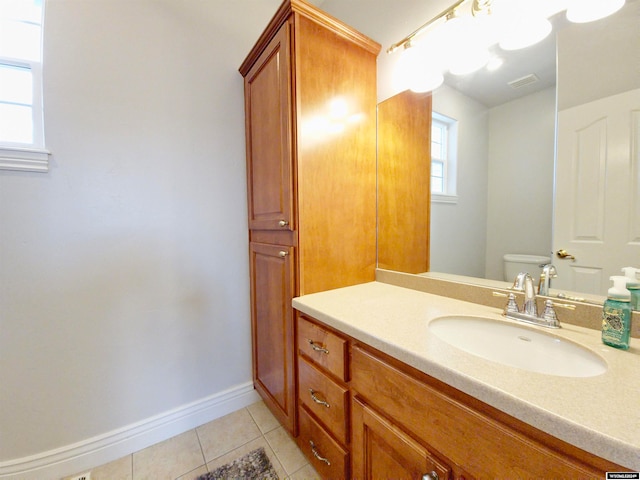 bathroom featuring vanity, tile patterned floors, and toilet