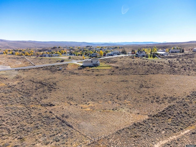 birds eye view of property featuring a mountain view