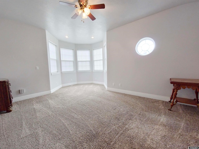 spare room featuring carpet flooring and ceiling fan