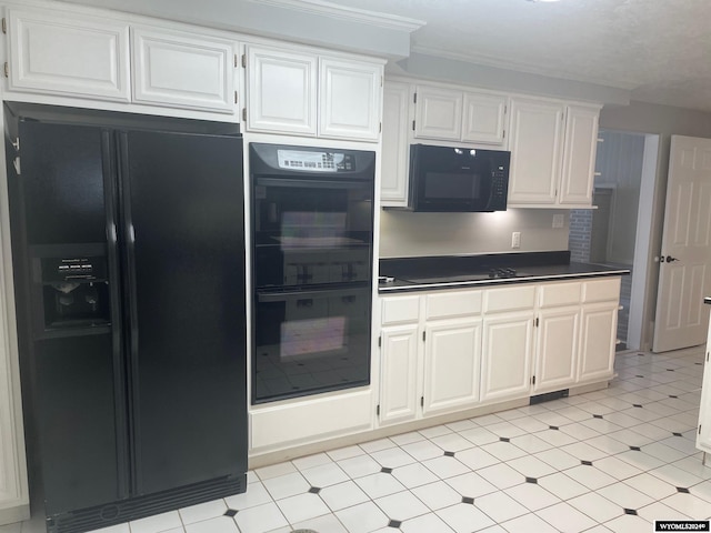 kitchen featuring white cabinets, crown molding, light tile floors, and black appliances