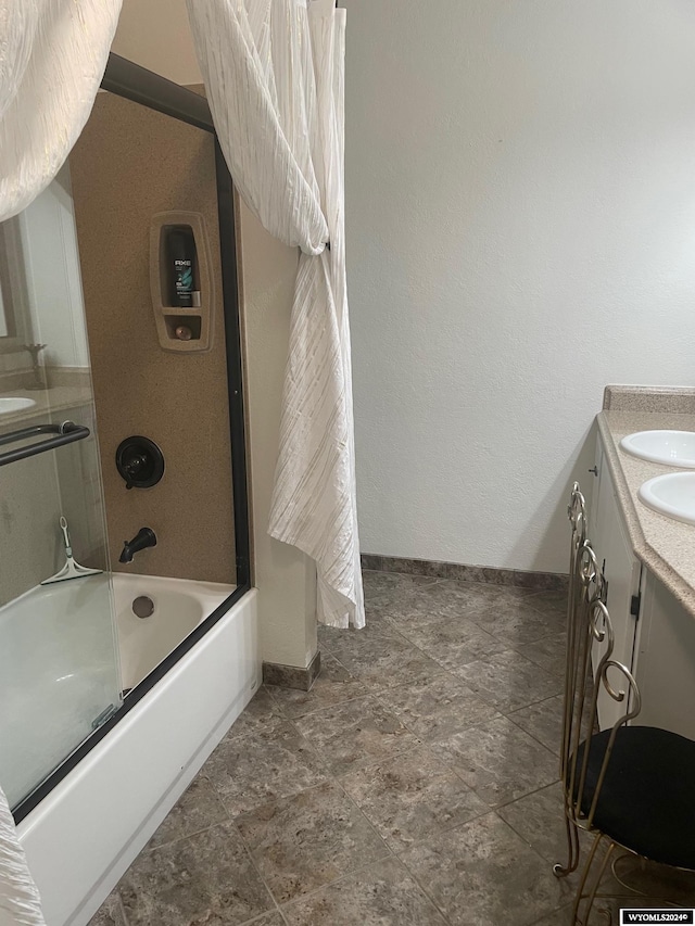 bathroom featuring dual vanity, combined bath / shower with glass door, and tile flooring