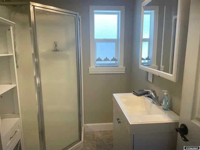 bathroom with tile flooring, vanity, and a shower with shower door