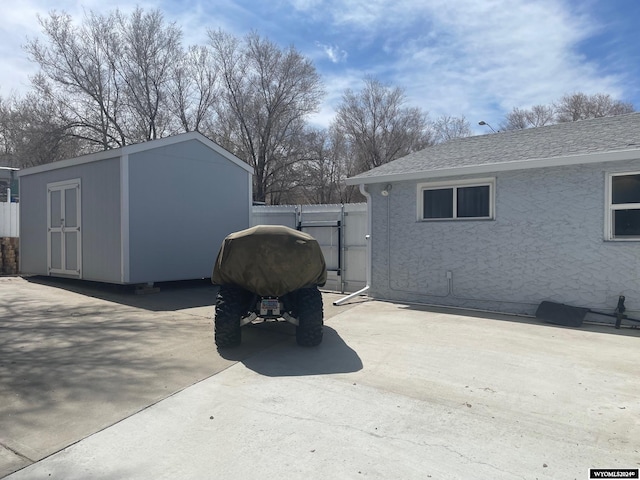 view of side of property featuring a storage unit and a patio area