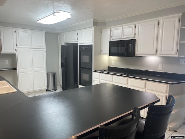 kitchen featuring ornamental molding, white cabinets, black appliances, and light tile flooring