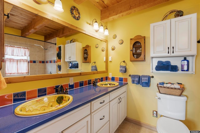 bathroom with large vanity, toilet, beamed ceiling, double sink, and wood ceiling