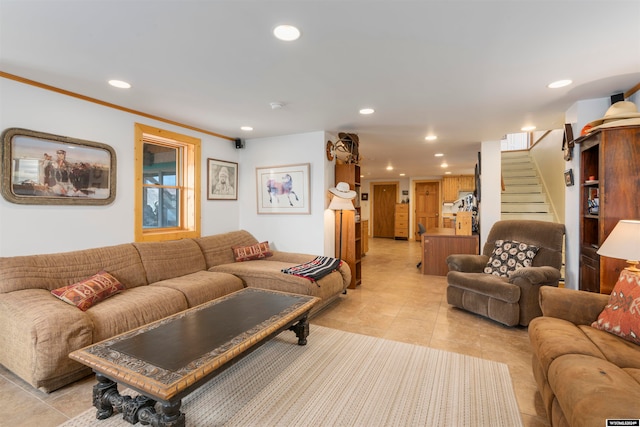 living room with light tile floors and ornamental molding