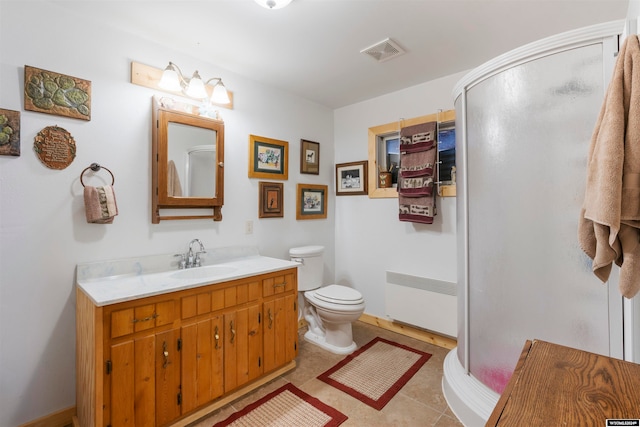 bathroom featuring vanity, a shower with shower door, radiator, tile flooring, and toilet