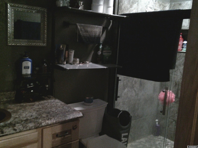 bathroom with vanity and a tile shower