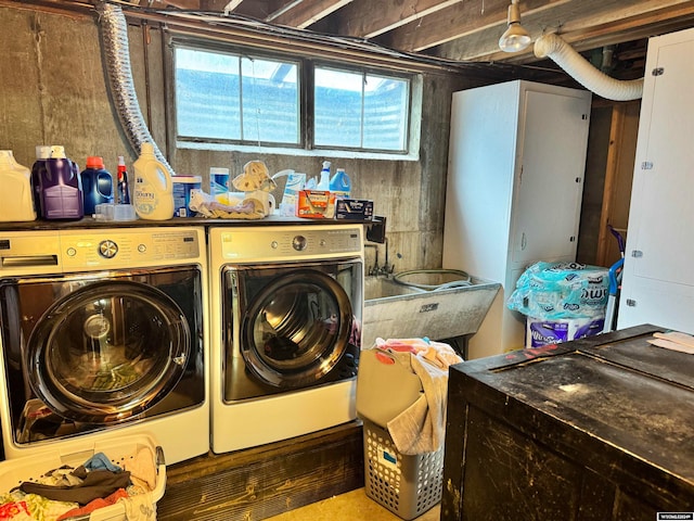 washroom with wood walls and washer and clothes dryer