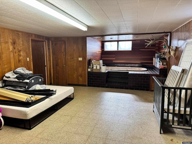 bedroom featuring wood walls and tile floors