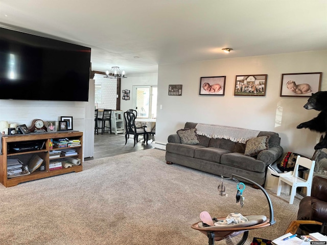 carpeted living room with a notable chandelier and a baseboard radiator