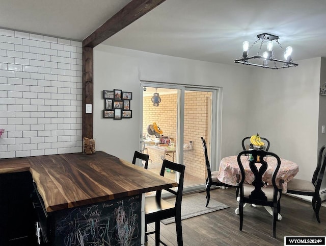 dining room with an inviting chandelier, beamed ceiling, and dark hardwood / wood-style floors