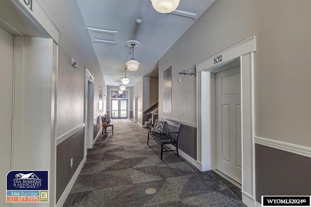 corridor with dark colored carpet