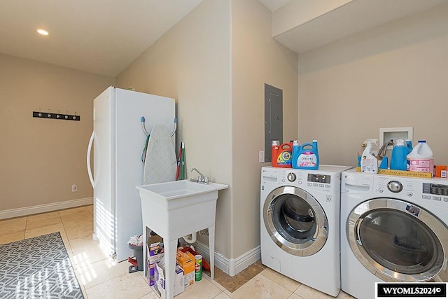 laundry area with washer and dryer, light tile floors, and washer hookup