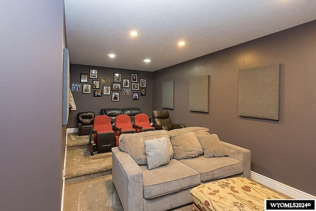 cinema room featuring a textured ceiling and carpet floors