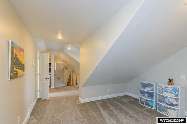 bonus room featuring carpet floors and vaulted ceiling