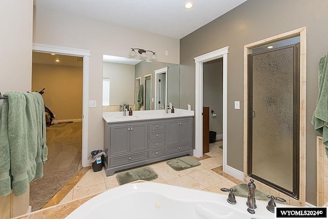 bathroom with dual sinks, plus walk in shower, oversized vanity, and tile flooring