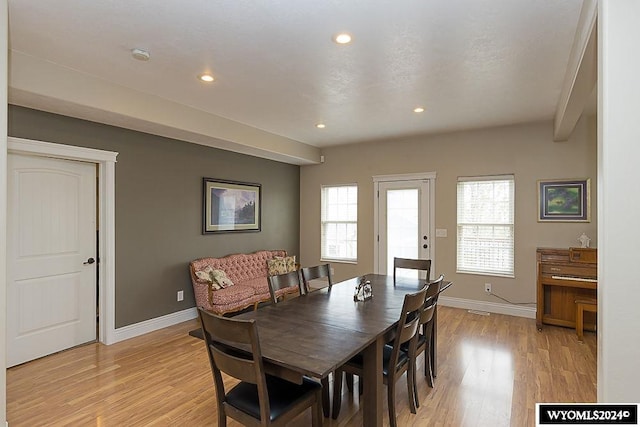 dining space with light hardwood / wood-style flooring