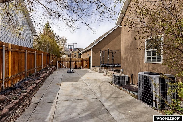 view of patio / terrace with a trampoline and central AC unit