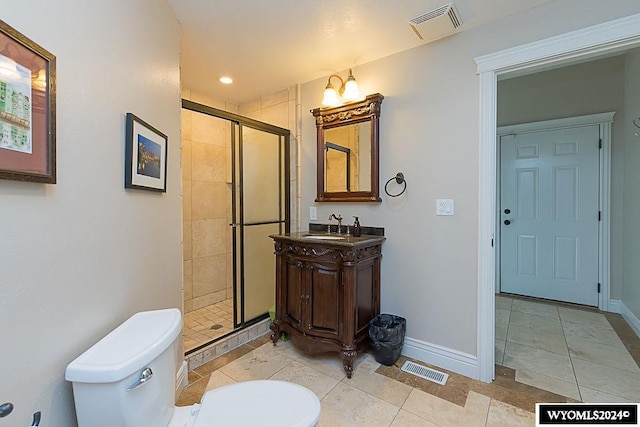 bathroom featuring tile floors, an enclosed shower, toilet, and large vanity