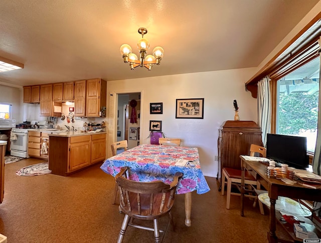 dining area featuring light carpet and a notable chandelier